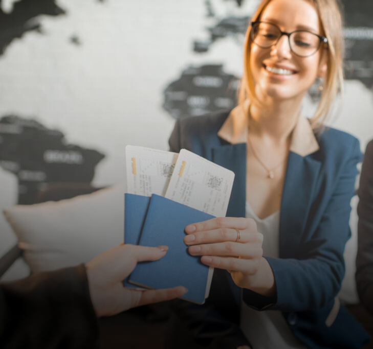 Soccer team in red jerseys huddling together on field at sunset.