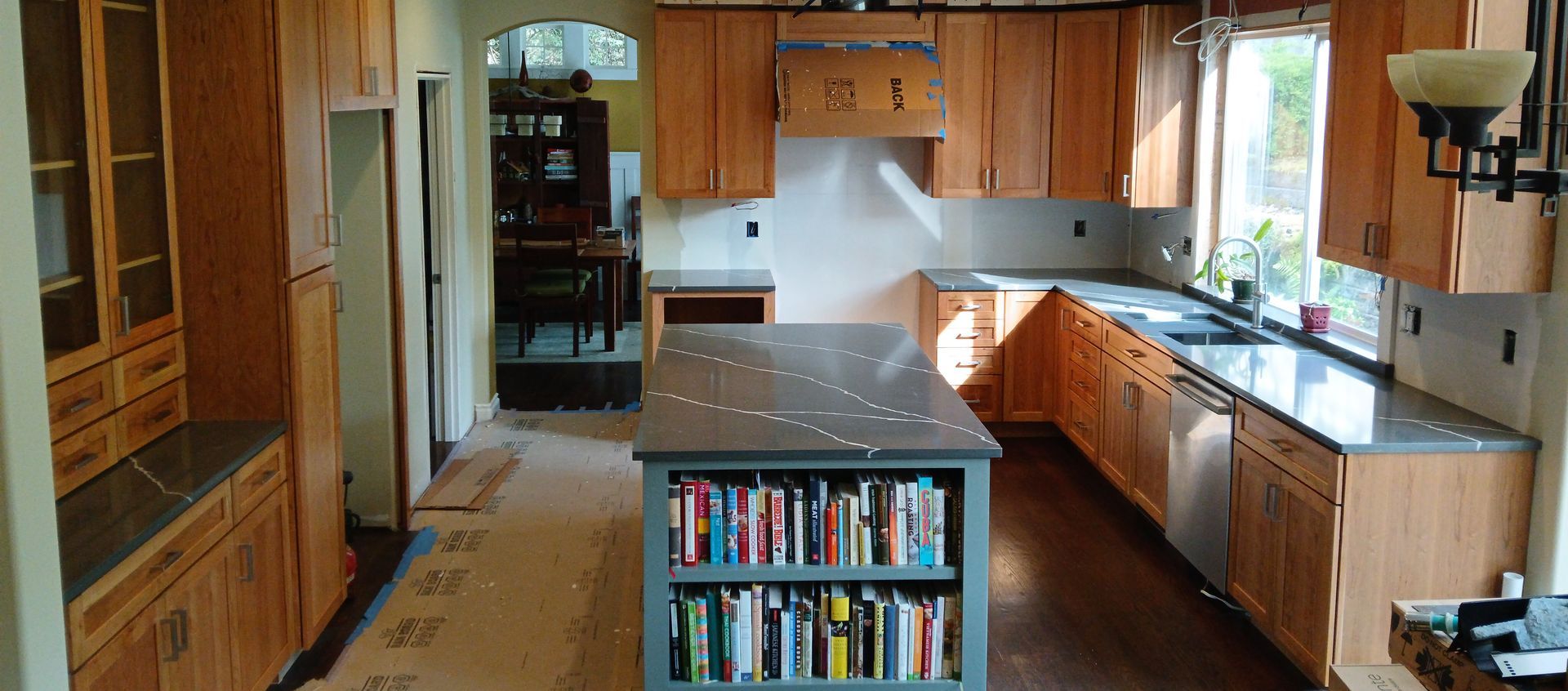 A kitchen with wooden cabinets and granite counter tops