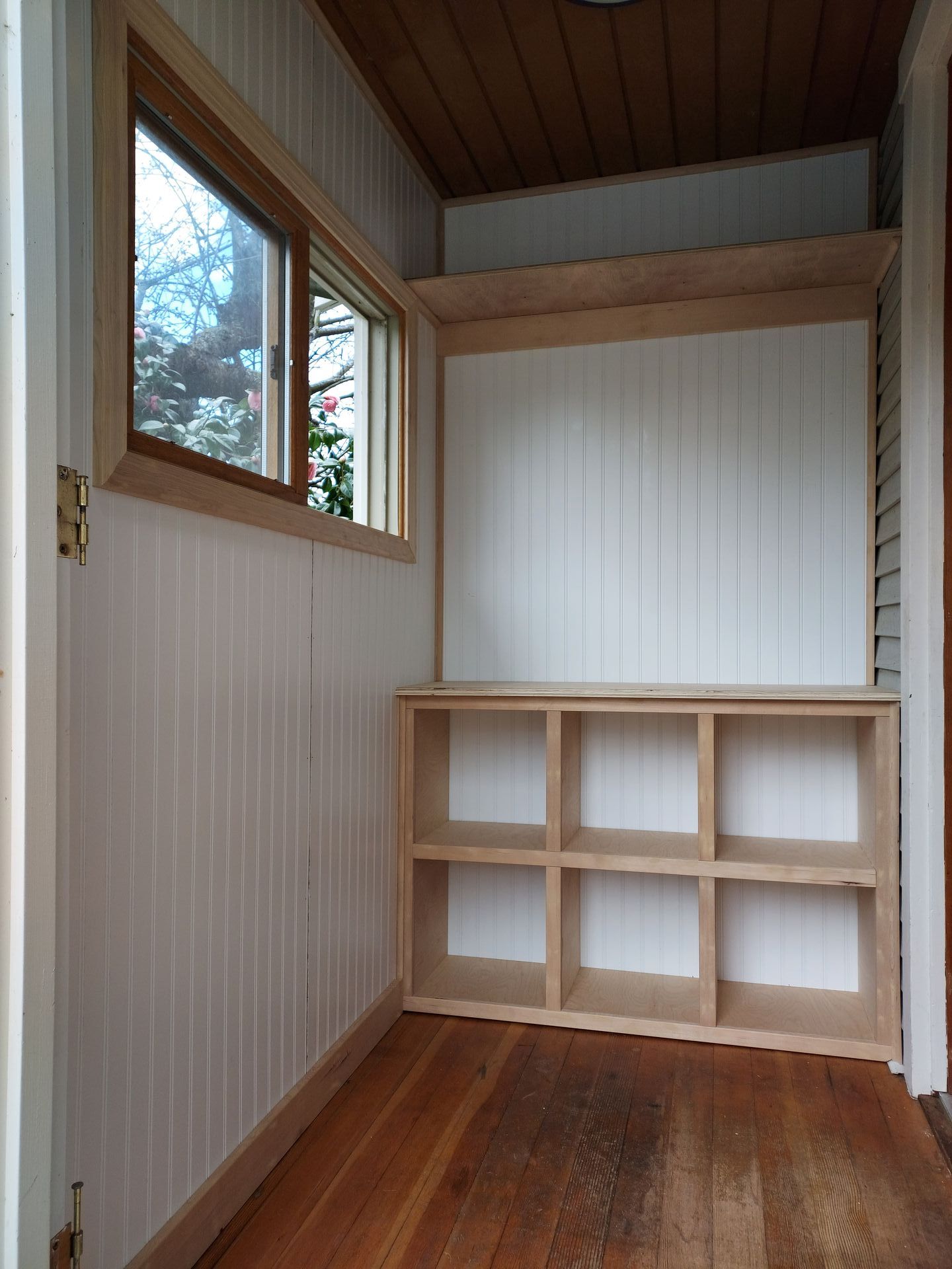 A room with wooden shelves and a window