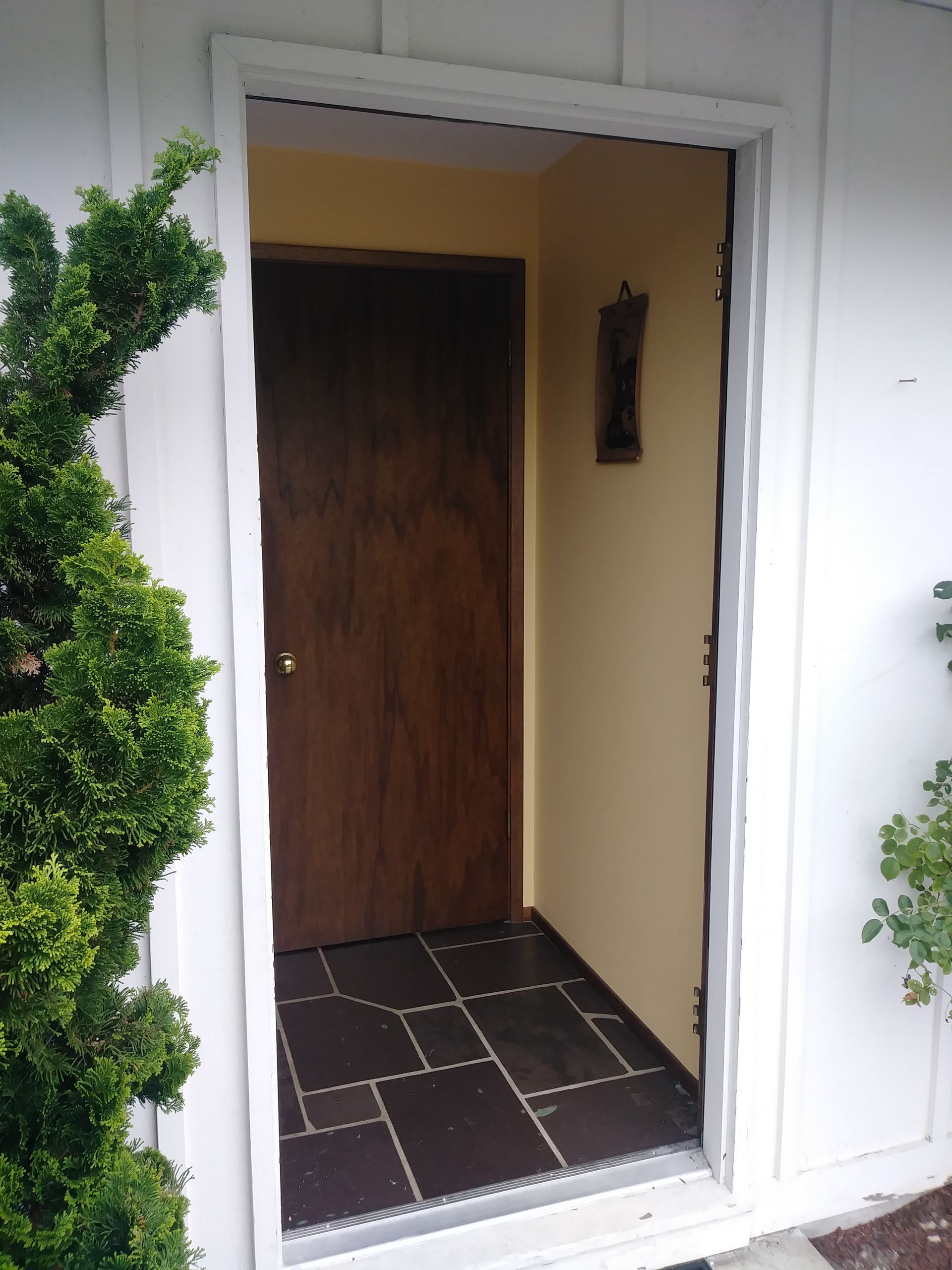 A door with a clock on the wall behind it