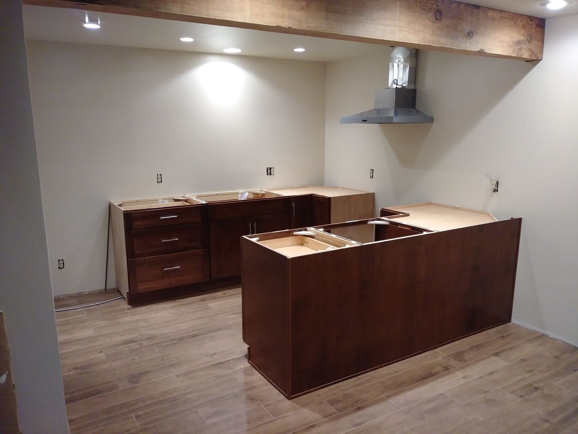 A kitchen with wooden cabinets and a large island