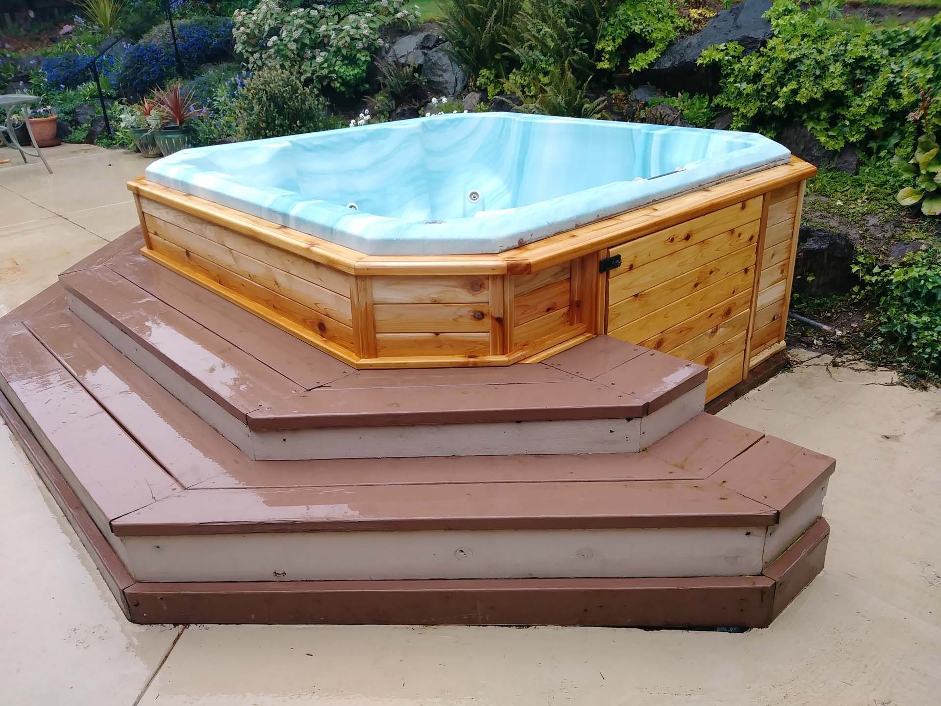 A hot tub sitting on top of a wooden deck