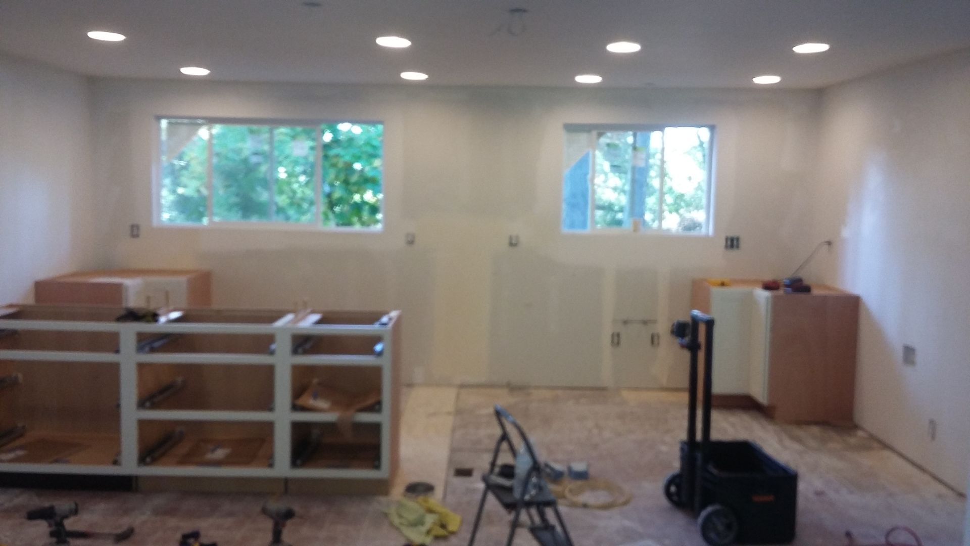 A room with a lot of cabinets and a window