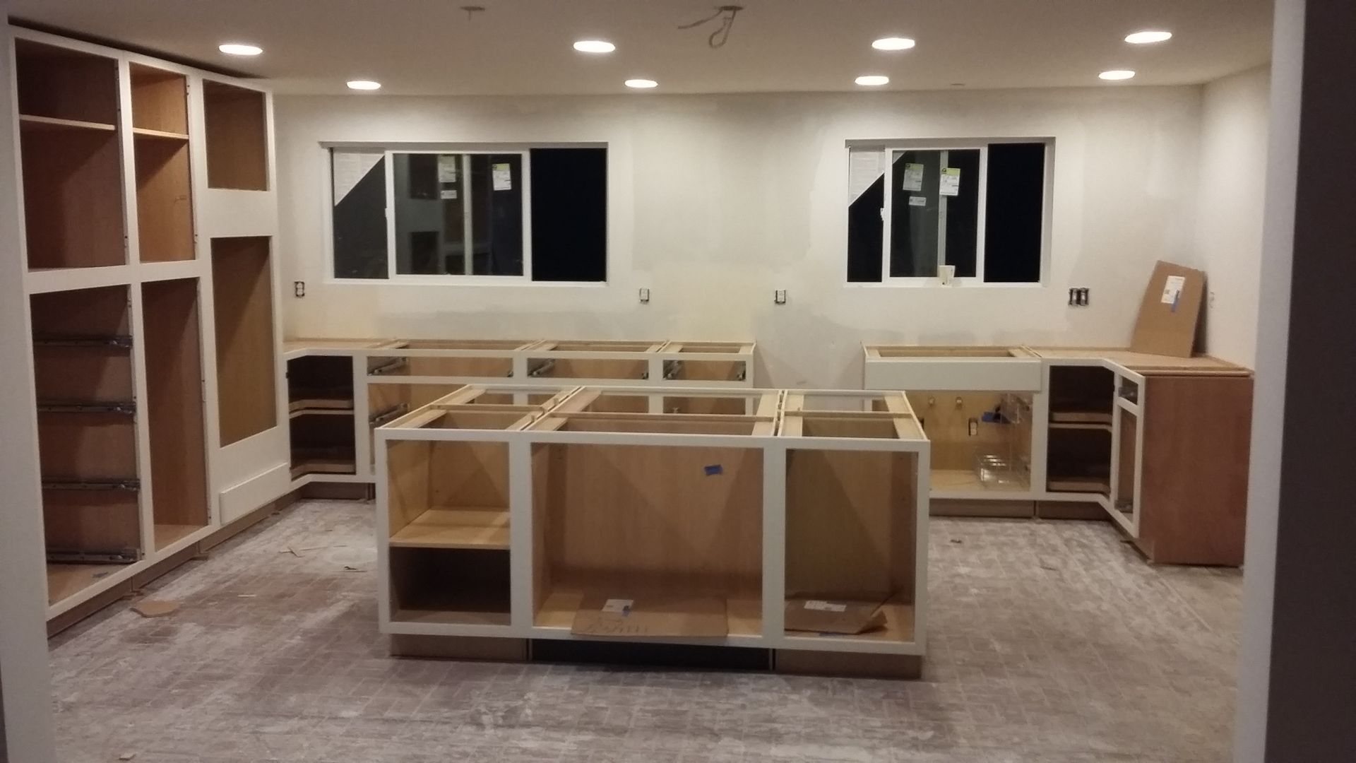 A room with a lot of cabinets and a window