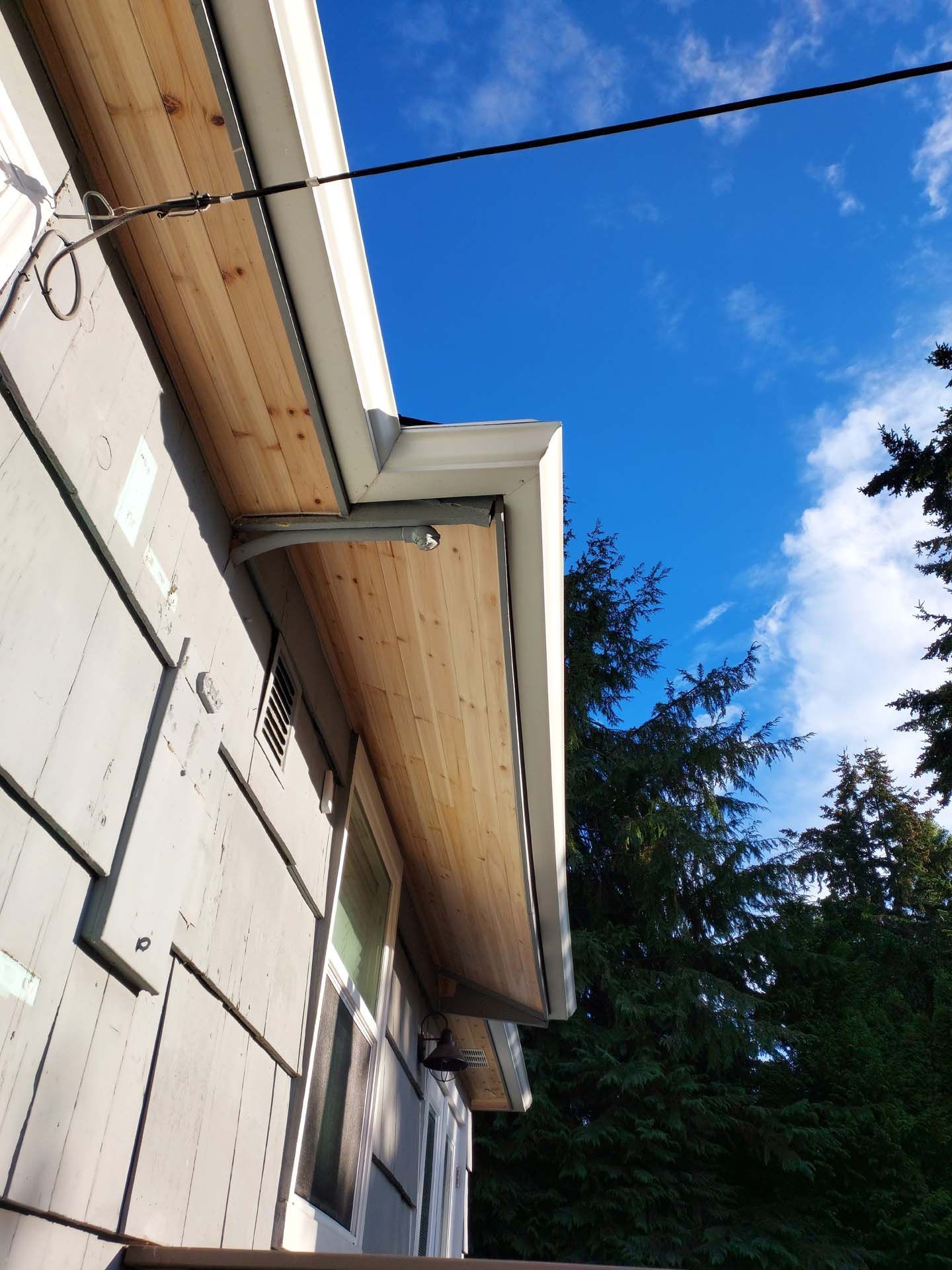 The roof of a house with a blue sky in the background