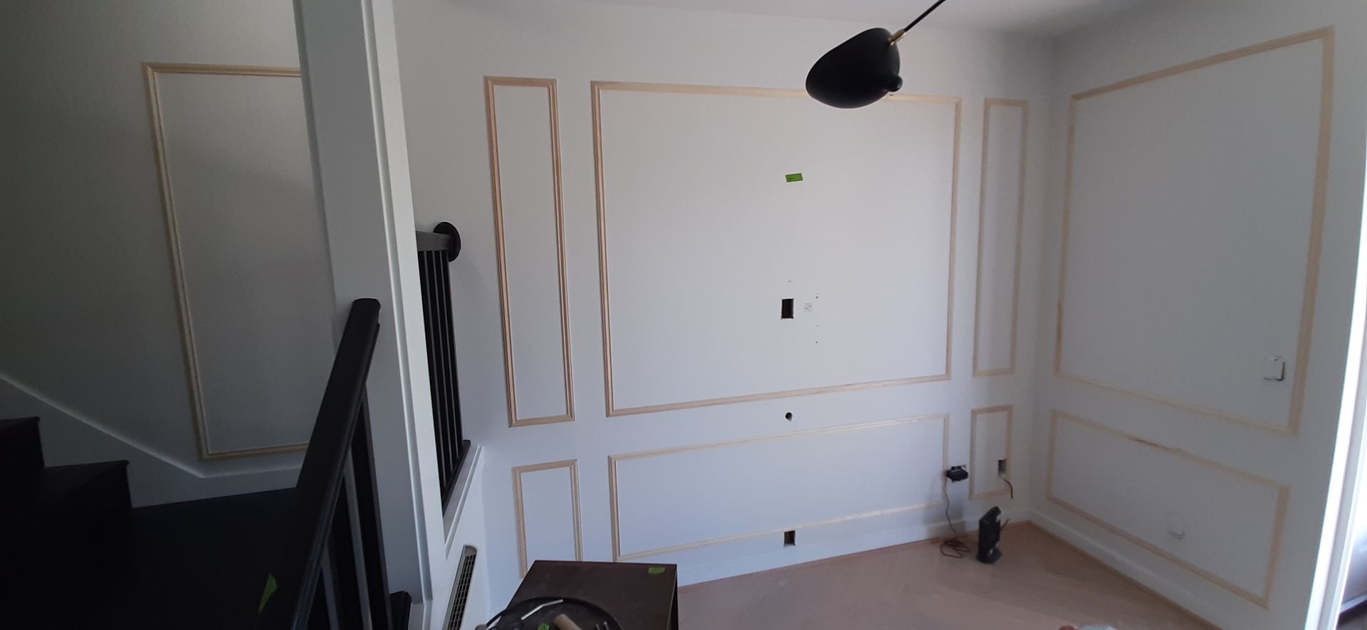 A room with a staircase and a ceiling fan in it.