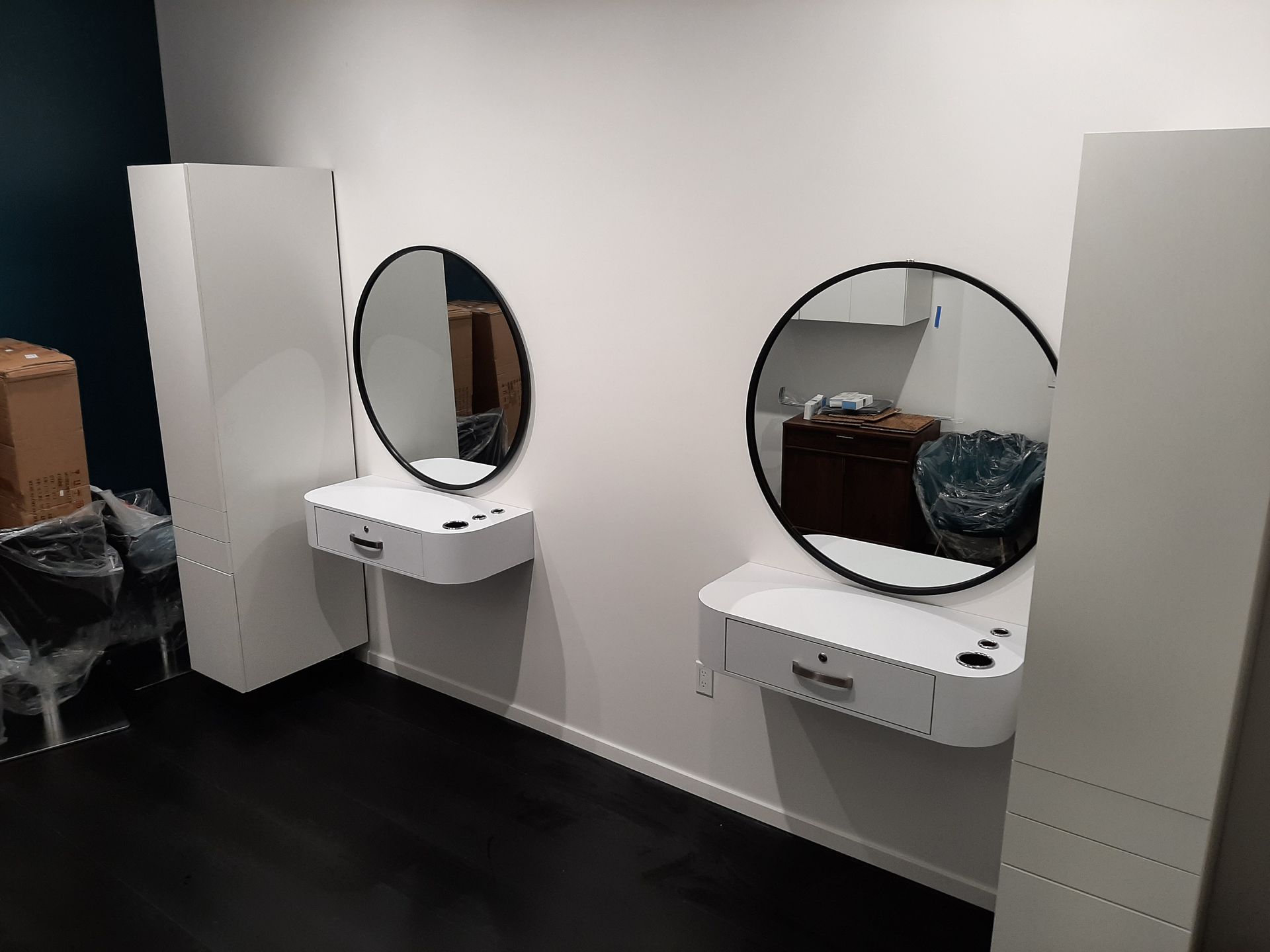 There are two mirrors on the wall in a room.