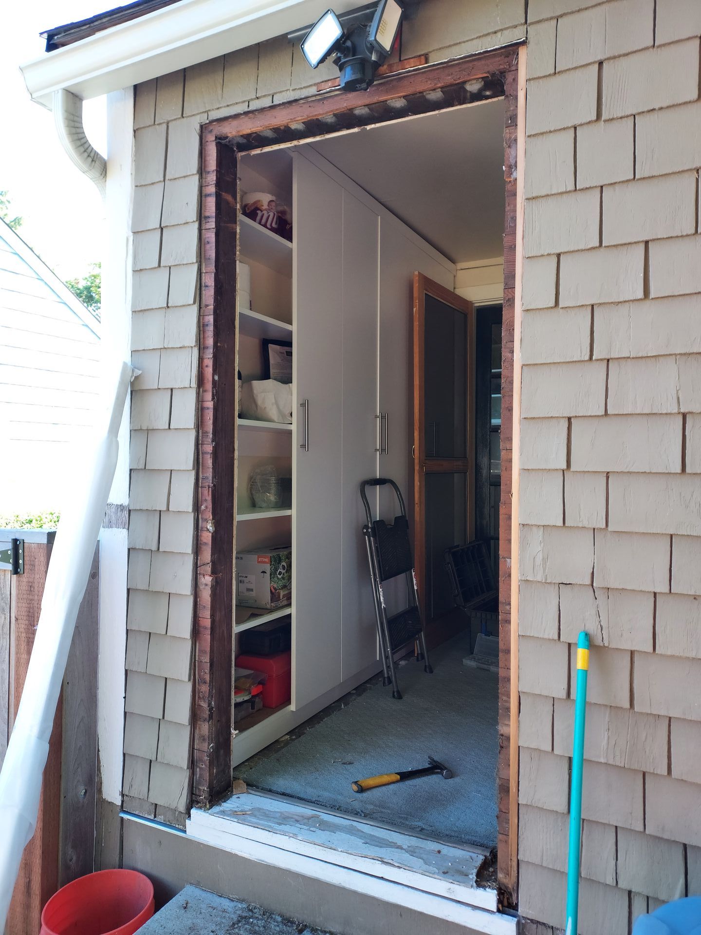 A brick building with a door that is open