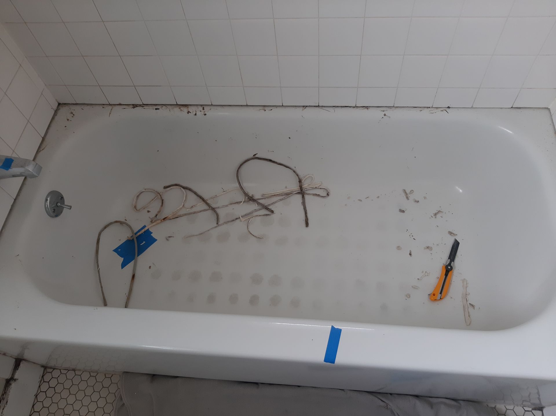 A bathtub is being remodeled in a bathroom.