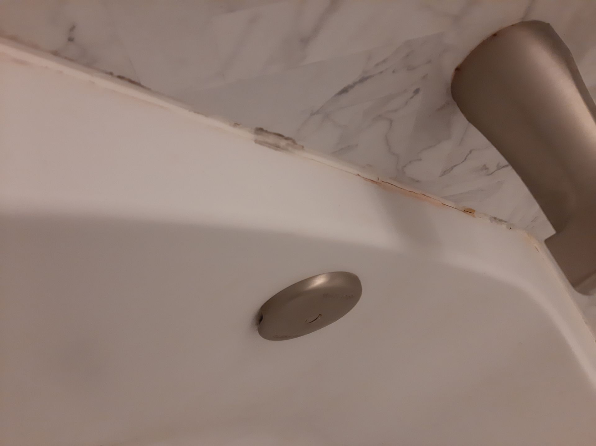 A close up of a bathtub with a faucet in a bathroom.