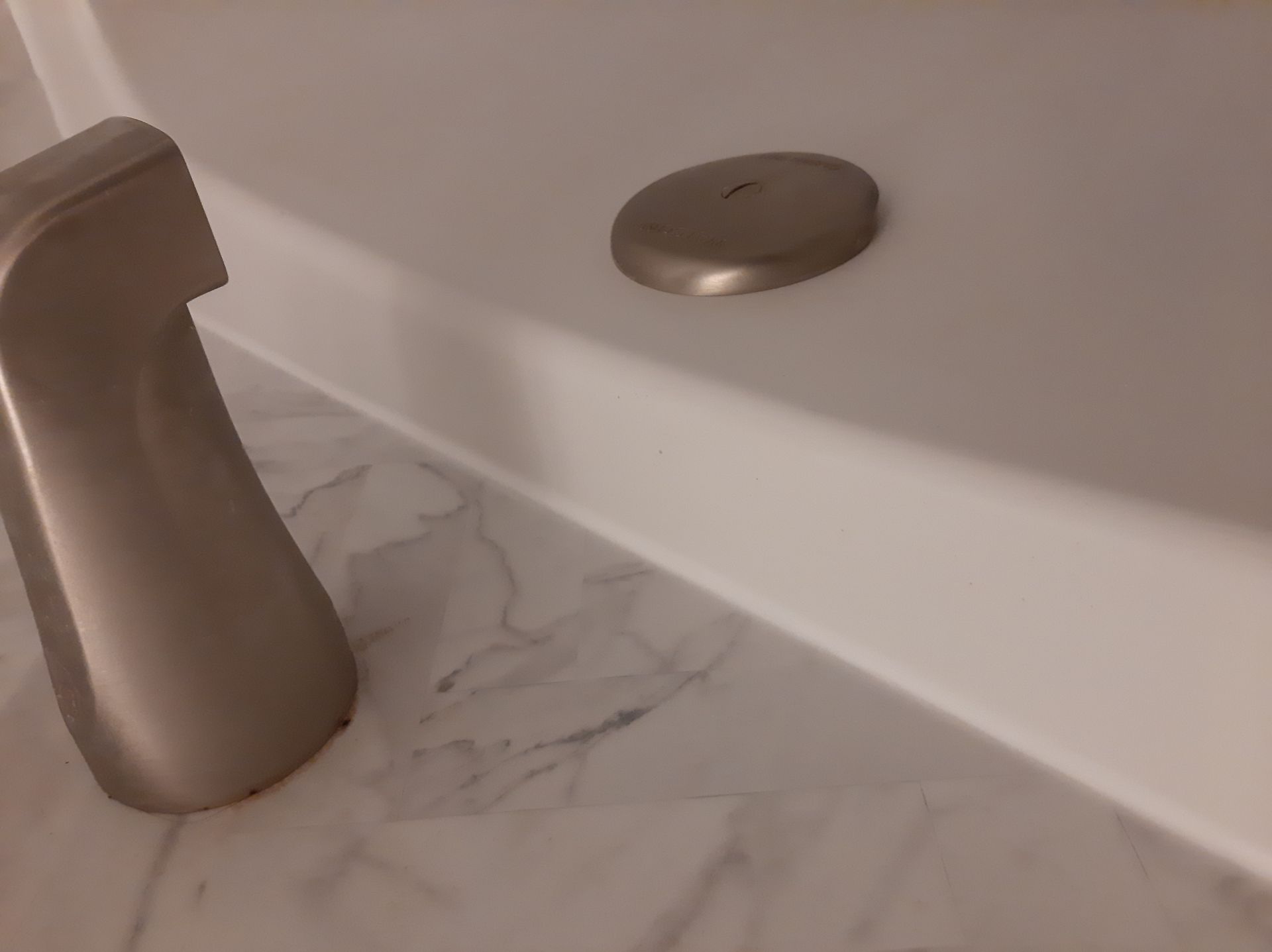 A bathtub with a faucet on the side of it