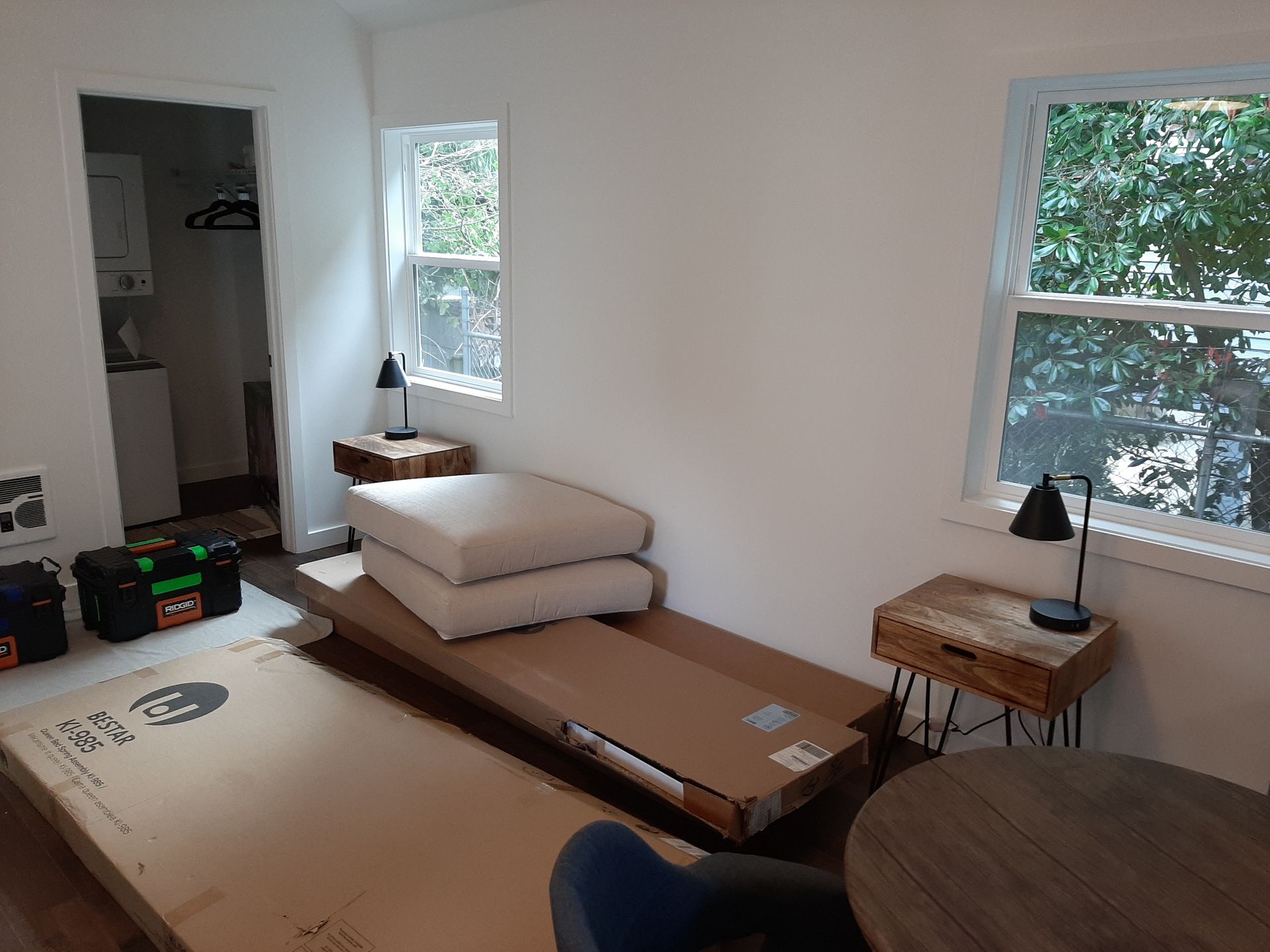 A living room with a cardboard box on the floor and a table.