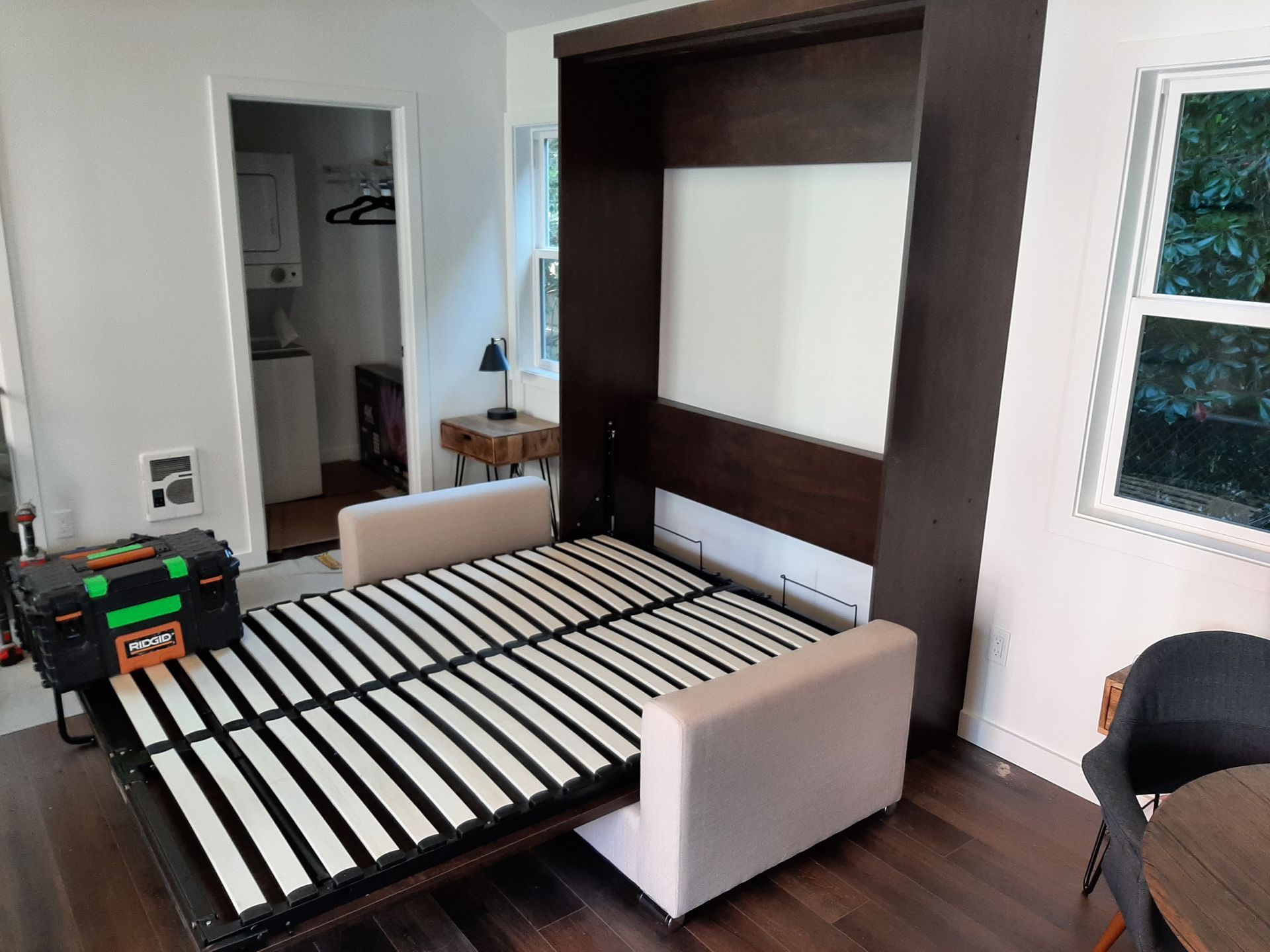 A couch is turned into a bed in a living room.