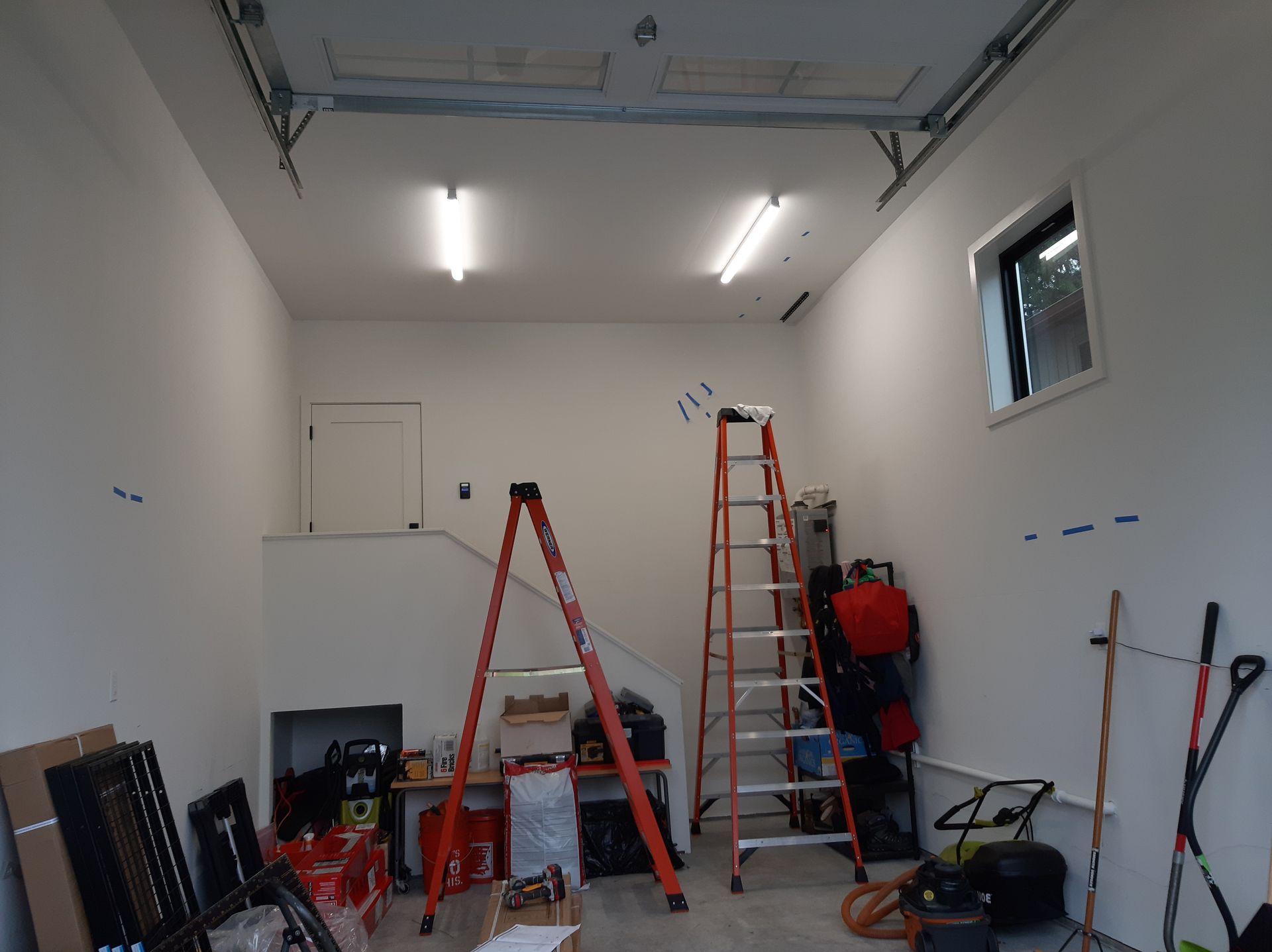 A garage with a ladder in the middle of it