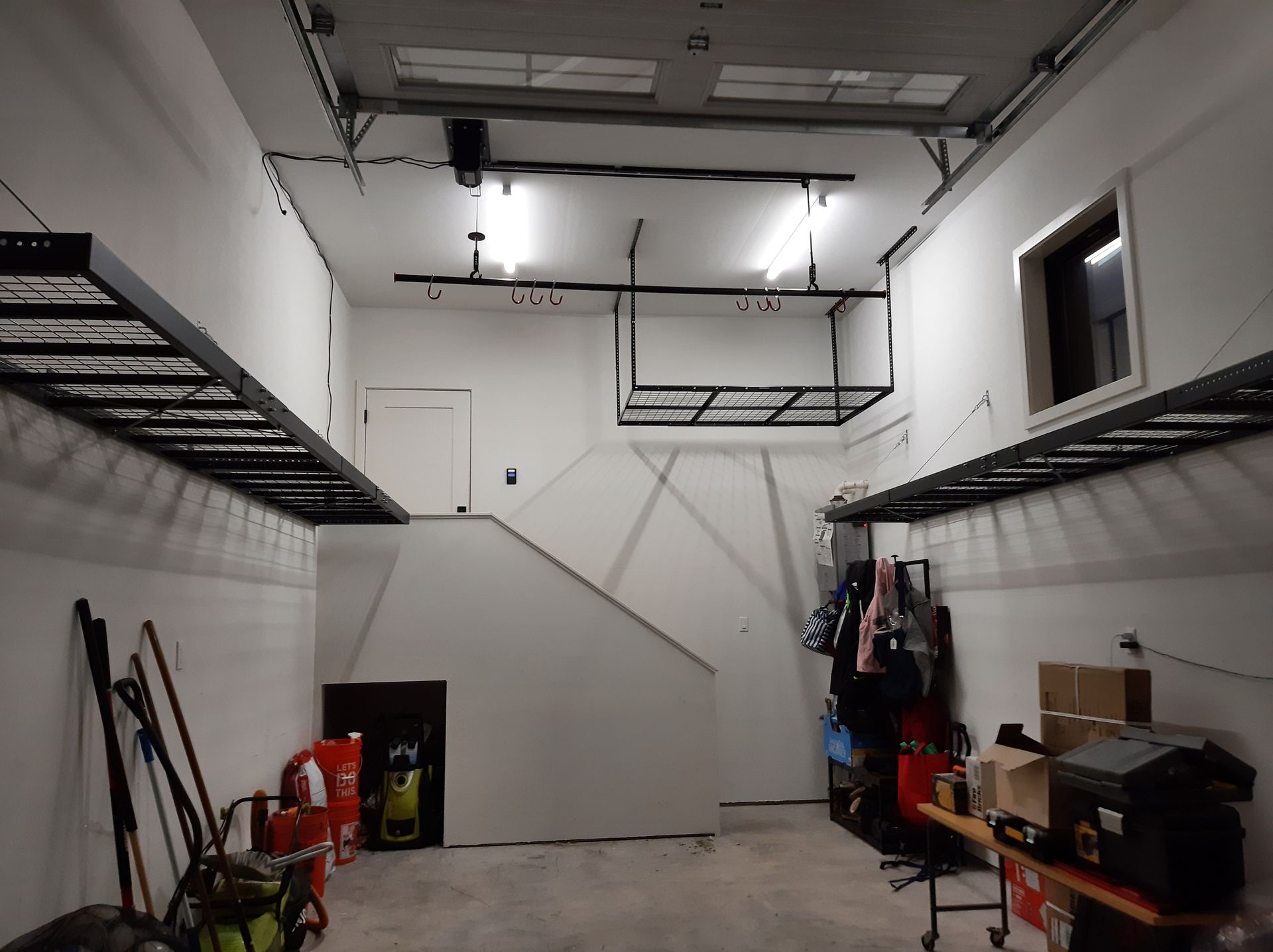 A garage with a ladder hanging from the ceiling