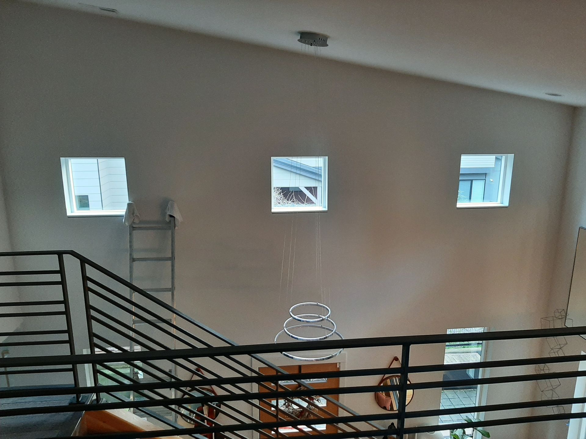 A view of a staircase from the second floor of a house.