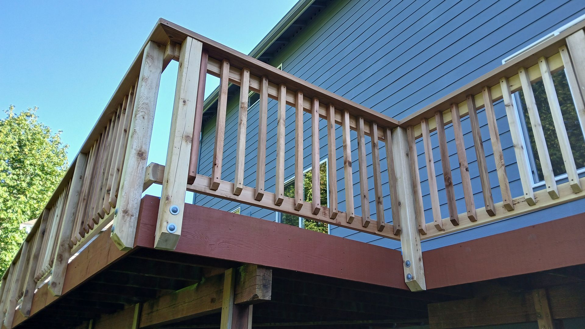 A wooden deck is attached to the side of a house.