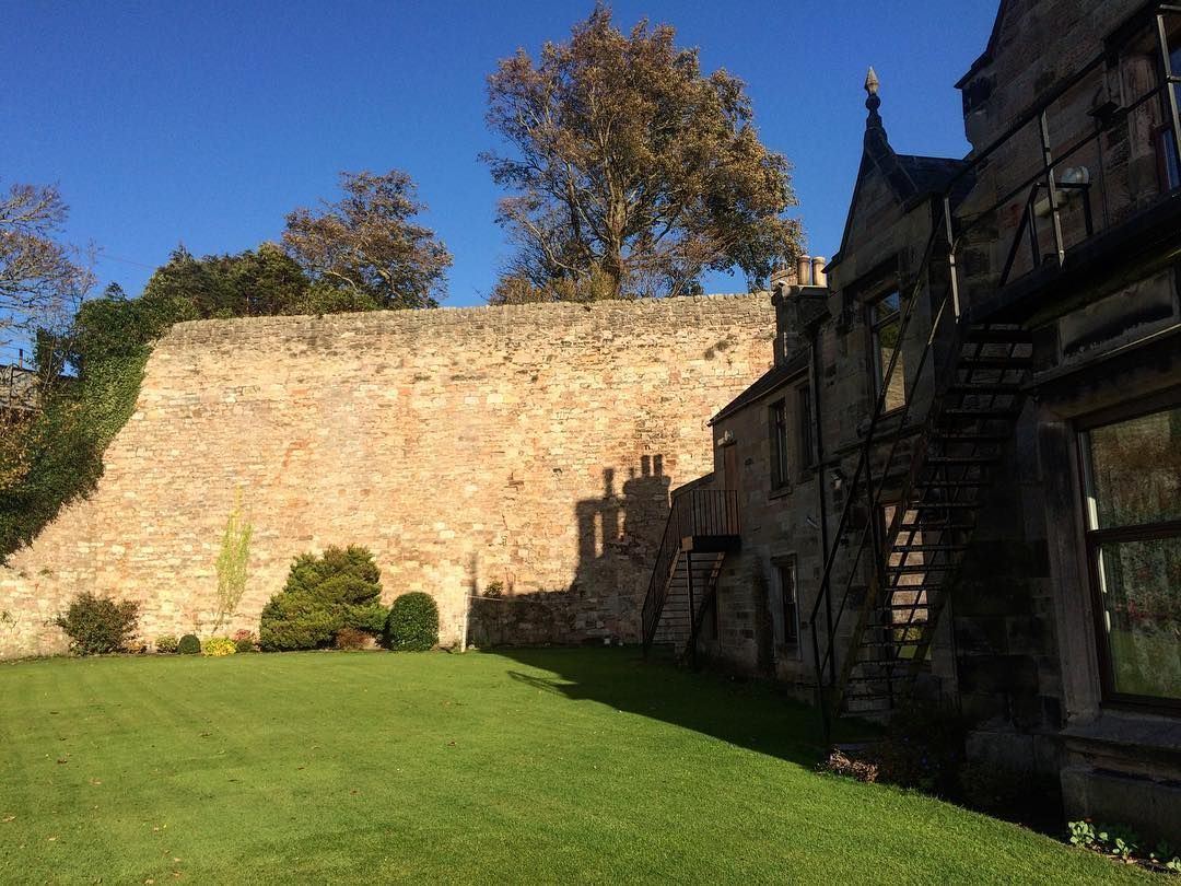 Side of house and castle wall 