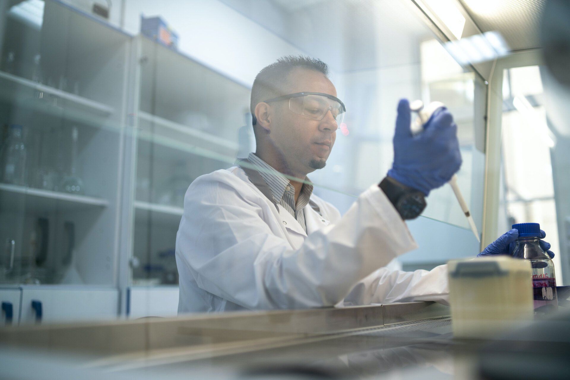 A male chemist conducting tests in the lab