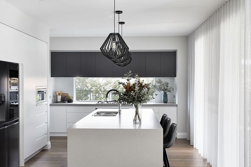 A kitchen with a large island in the middle of the room.