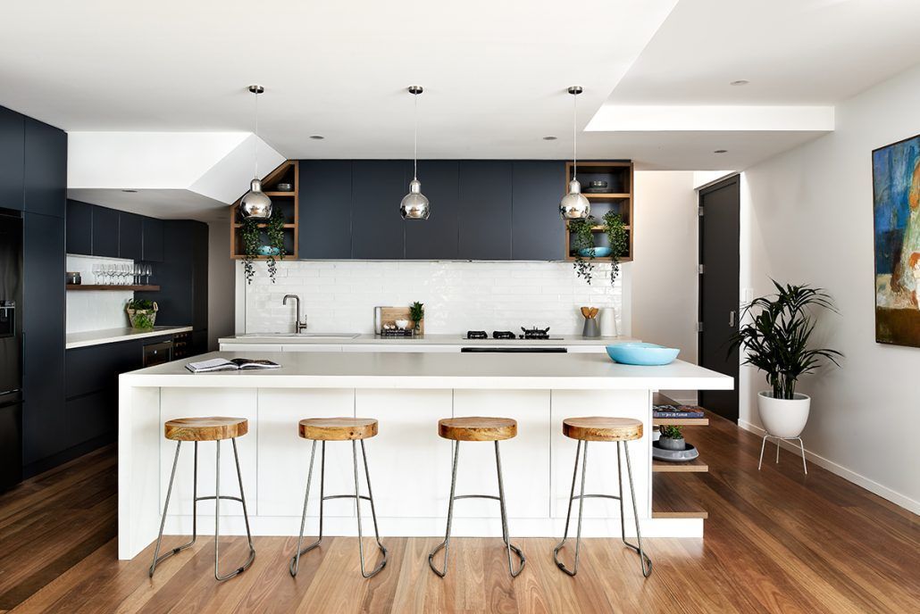 A kitchen with a large island and stools