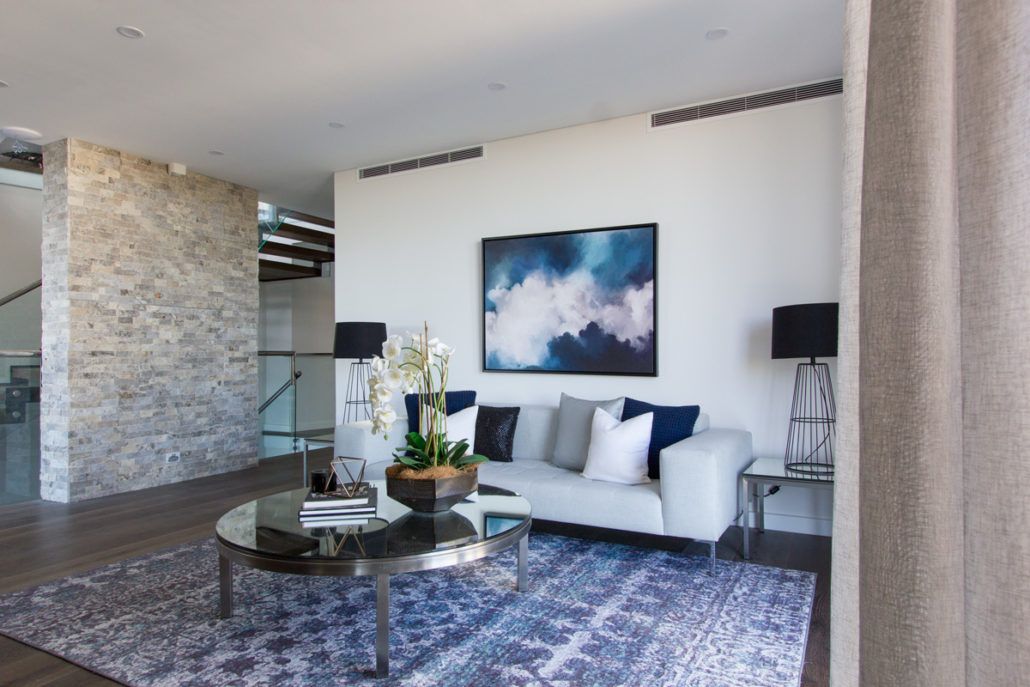 A living room with a couch , coffee table , and rug.