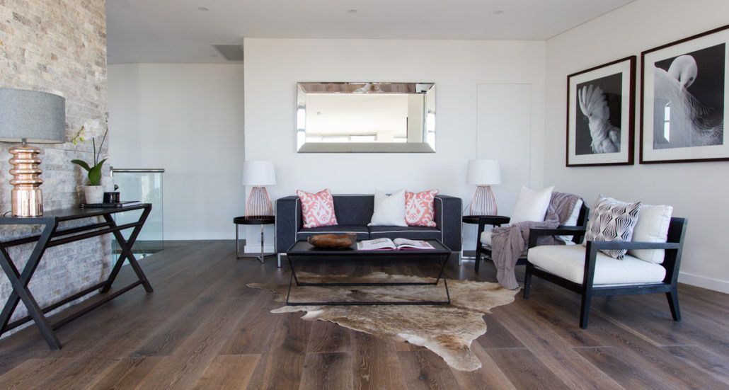 A living room with a couch and two chairs