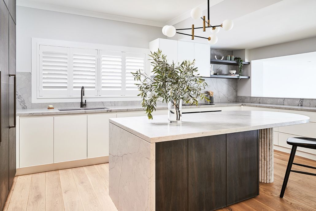 A kitchen with a large island in the middle of it.