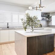 A kitchen with a large island and a sink.