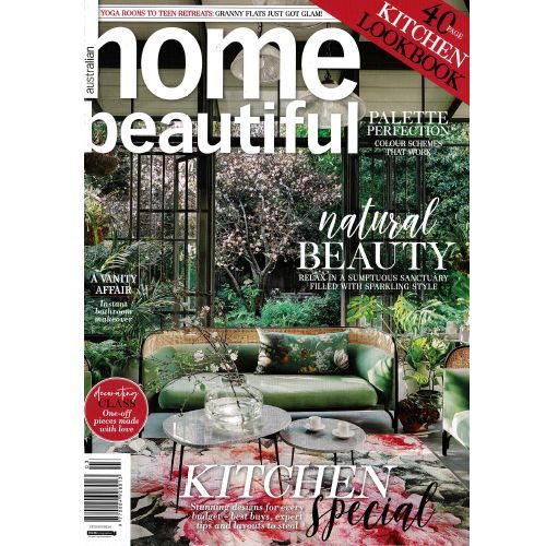 The cover of a home beautiful magazine with a couch and tables on it.