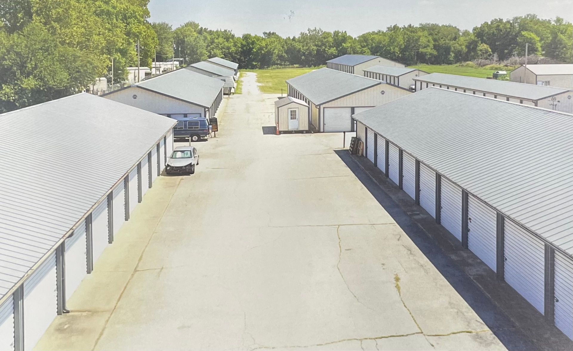 An aerial view of a parking lot with a lot of white buildings