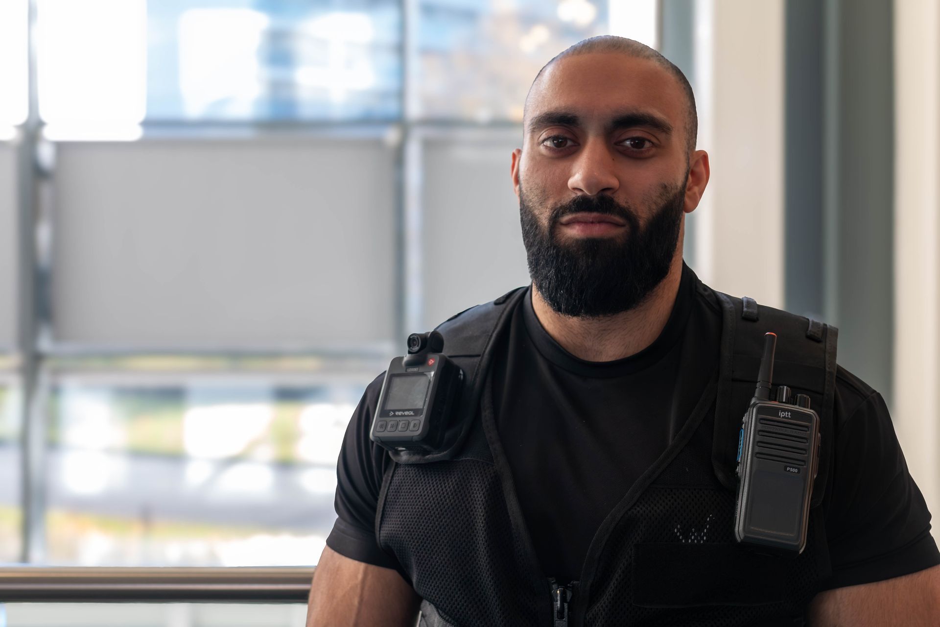 Woman standing at a security event wearing a professional uniform.