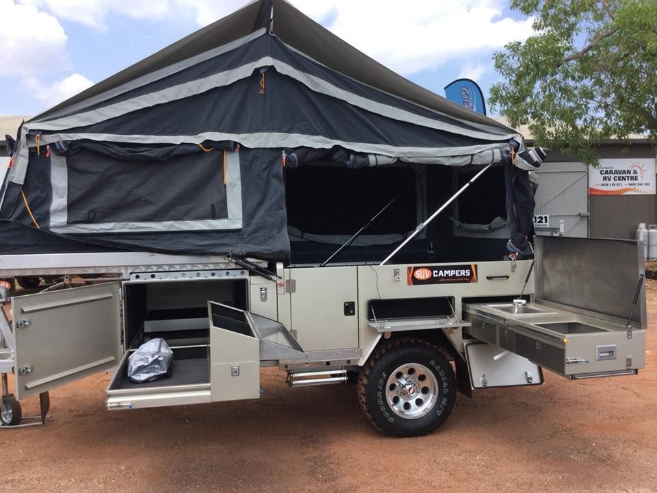 A Trailer With a Tent on Top of It is Parked in a Parking Lot — Darwin Caravan & RV Centre In Palmerston, NT
