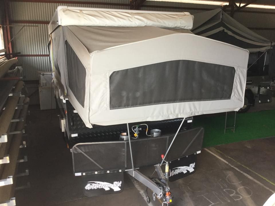 A Trailer With a Tent on Top of It is Parked in a Garage — Darwin Caravan & RV Centre In Berrimah, NT