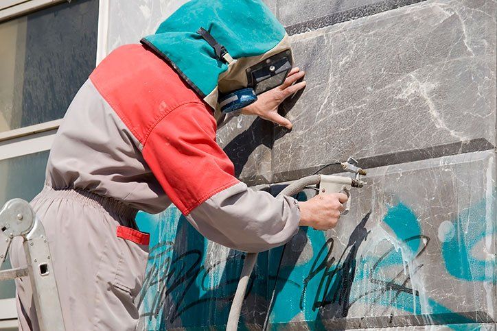 Worker Removing the Graffiti — Kingsport, TN — C&E Cleaning Services