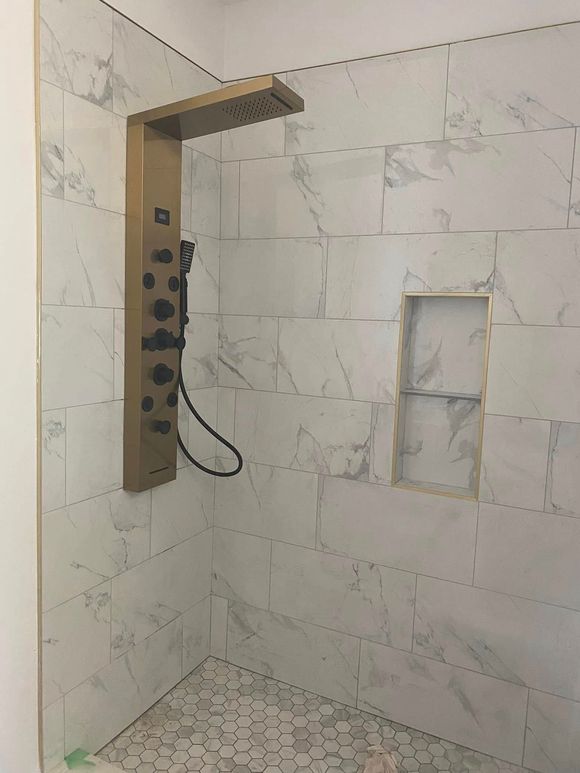 A bathroom with a toilet , sink and bathtub.