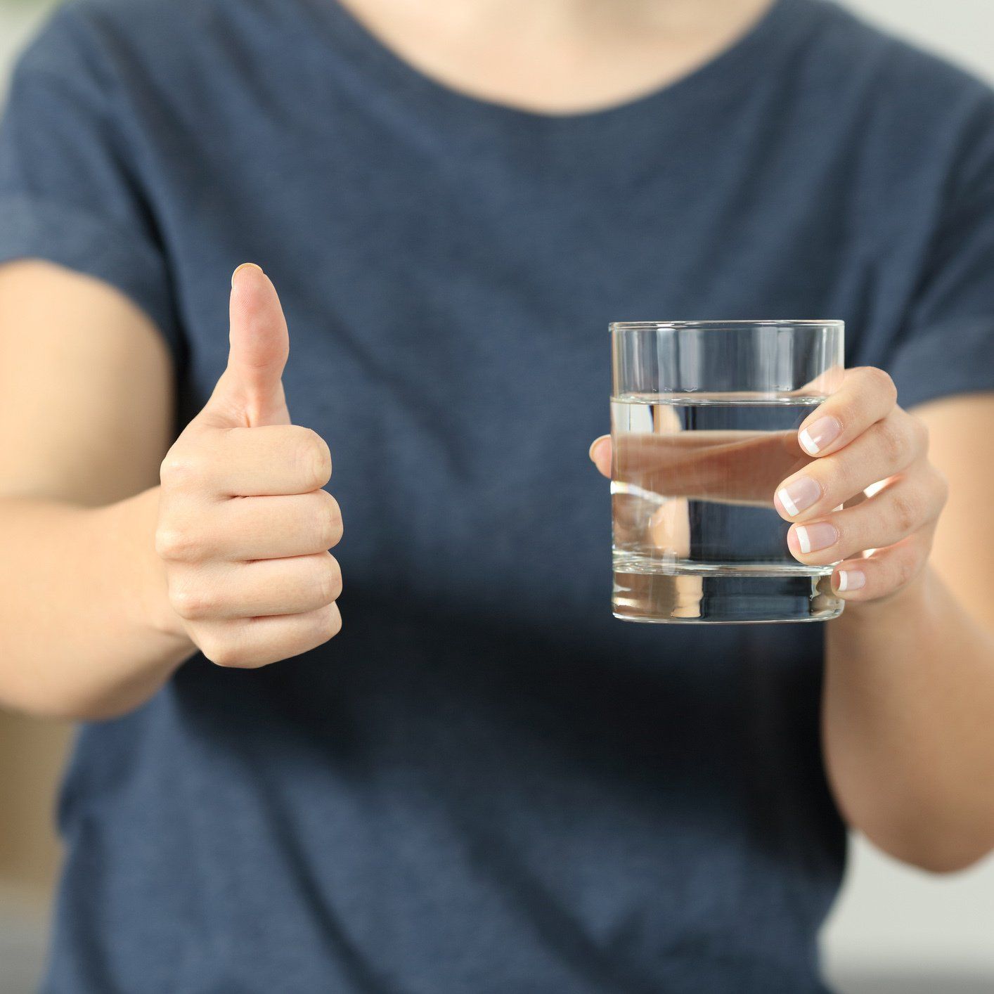 Woman with Water Glass and Thumbs Up — Orlando, FL — Florida Pure Water Solutions