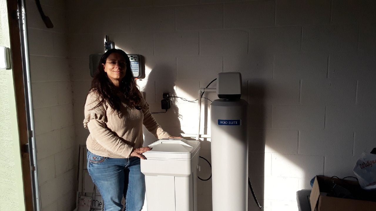 Smiling Woman and A Water Filtration Systems — Orlando, FL — Florida Pure Water Solutions