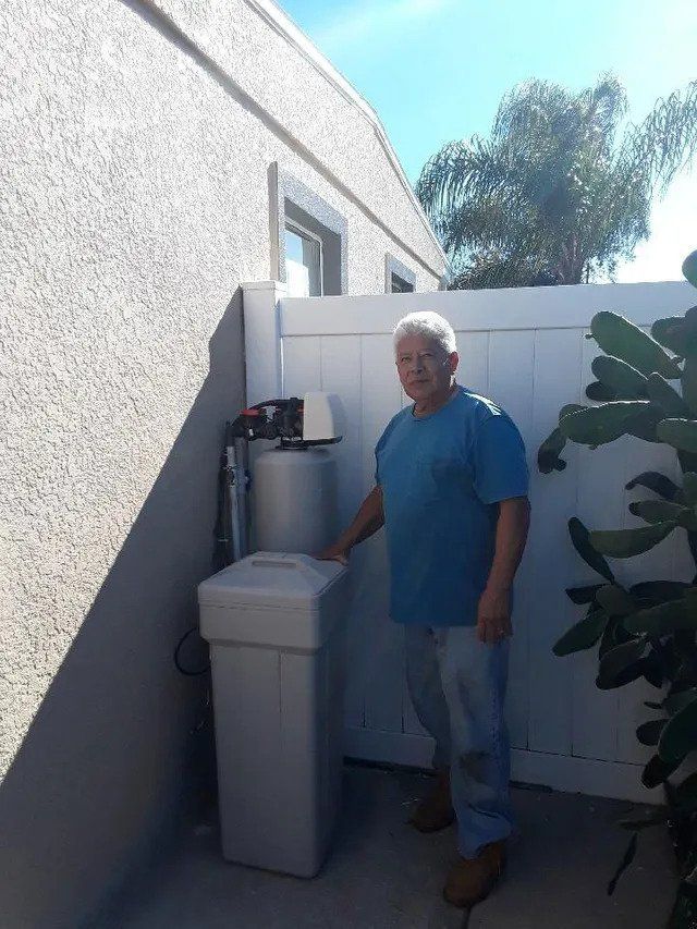 Man in a Blue Shirt and Water Filtration Systems  — Orlando, FL — Florida Pure Water Solutions