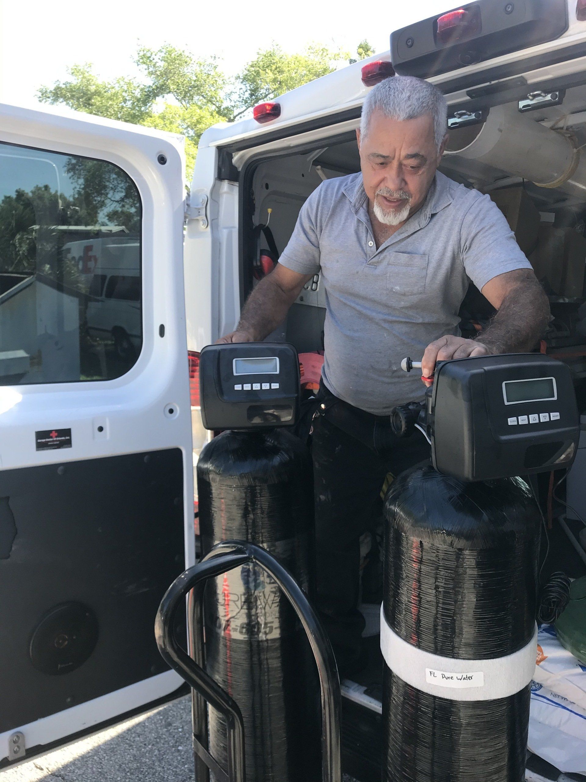 Man Holding Two Tanks — Orlando, FL — Florida Pure Water Solutions