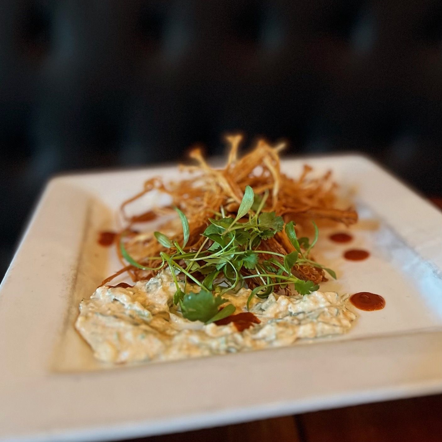 a white plate with a few pieces of food on it