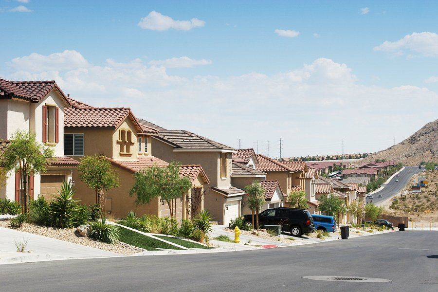 A row of houses with a fire hydrant on the side of the road