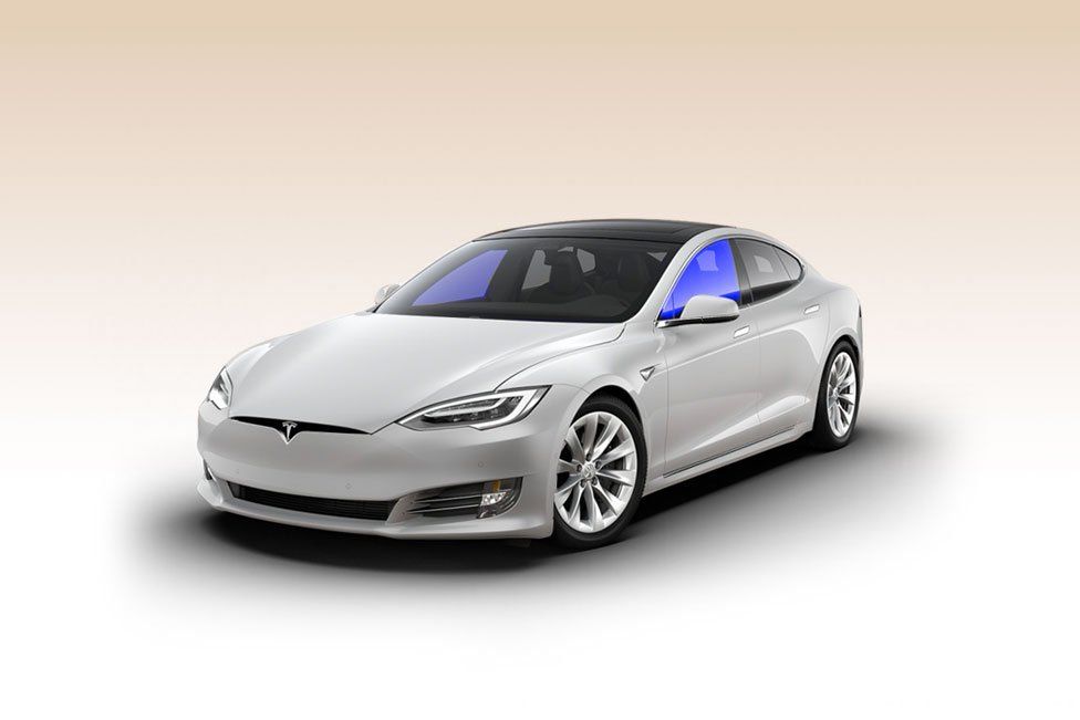 A white tesla model s is shown on a white background.