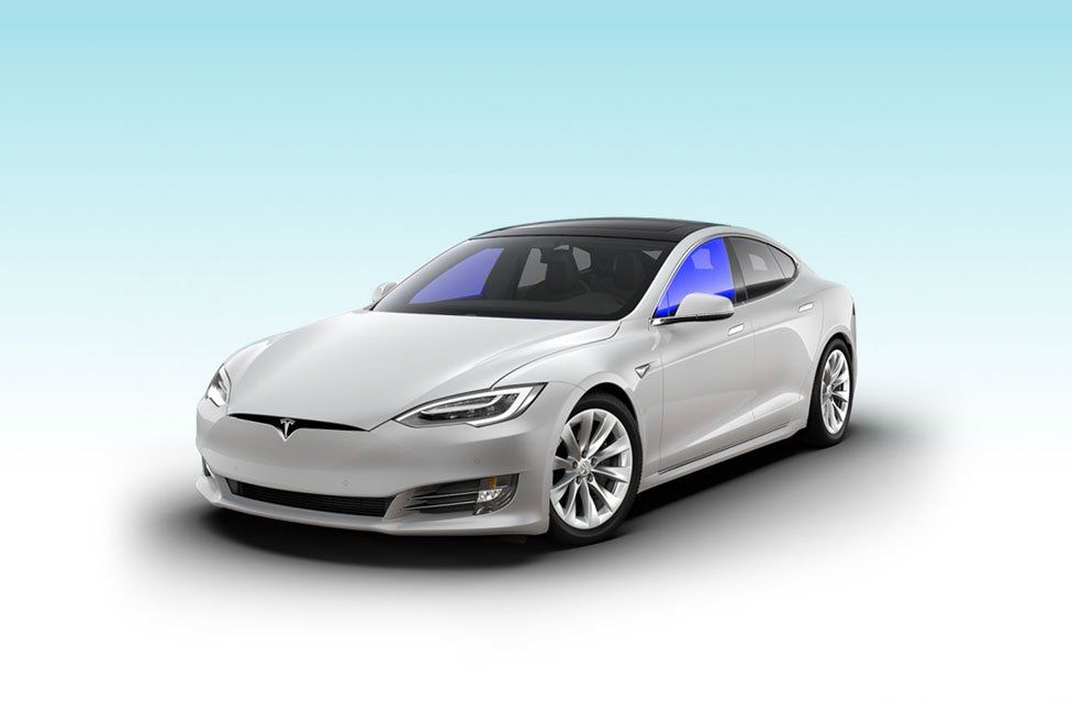 A white tesla model s is sitting on a blue background.