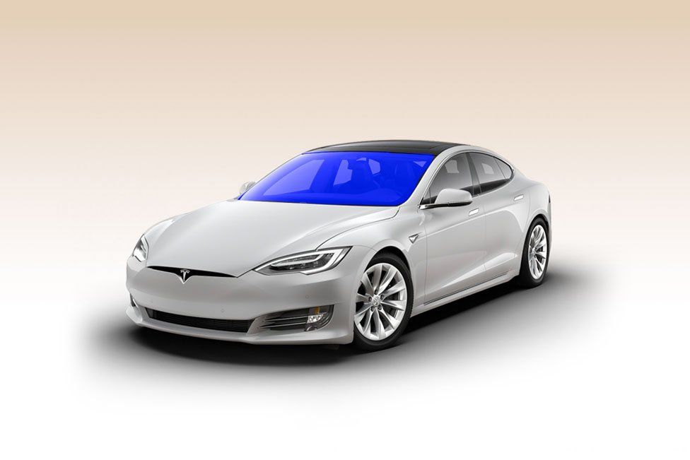 A white tesla model s with a blue windshield on a white background.