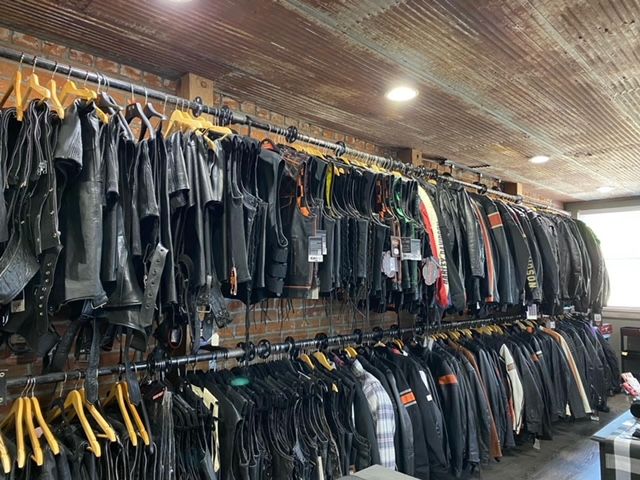 A store filled with lots of leather jackets hanging on racks. | Holt, MO| Re-Cycle Gear