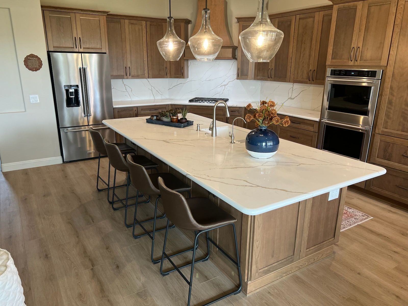 A kitchen with a large island and stainless steel appliances.