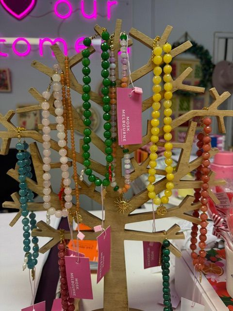 Close-up of Several Handmade Bracelets With Beads on White Cards — Decadence Gifts & Homewares in Springsure, QLD