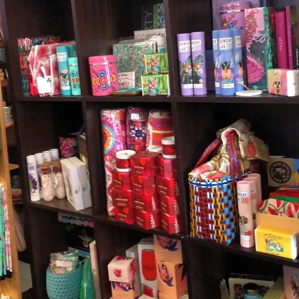 Wooden Shelves Stocked With Colourful Gift Items, Including Tea Tins — Decadence Gifts & Homewares in Springsure, QLD