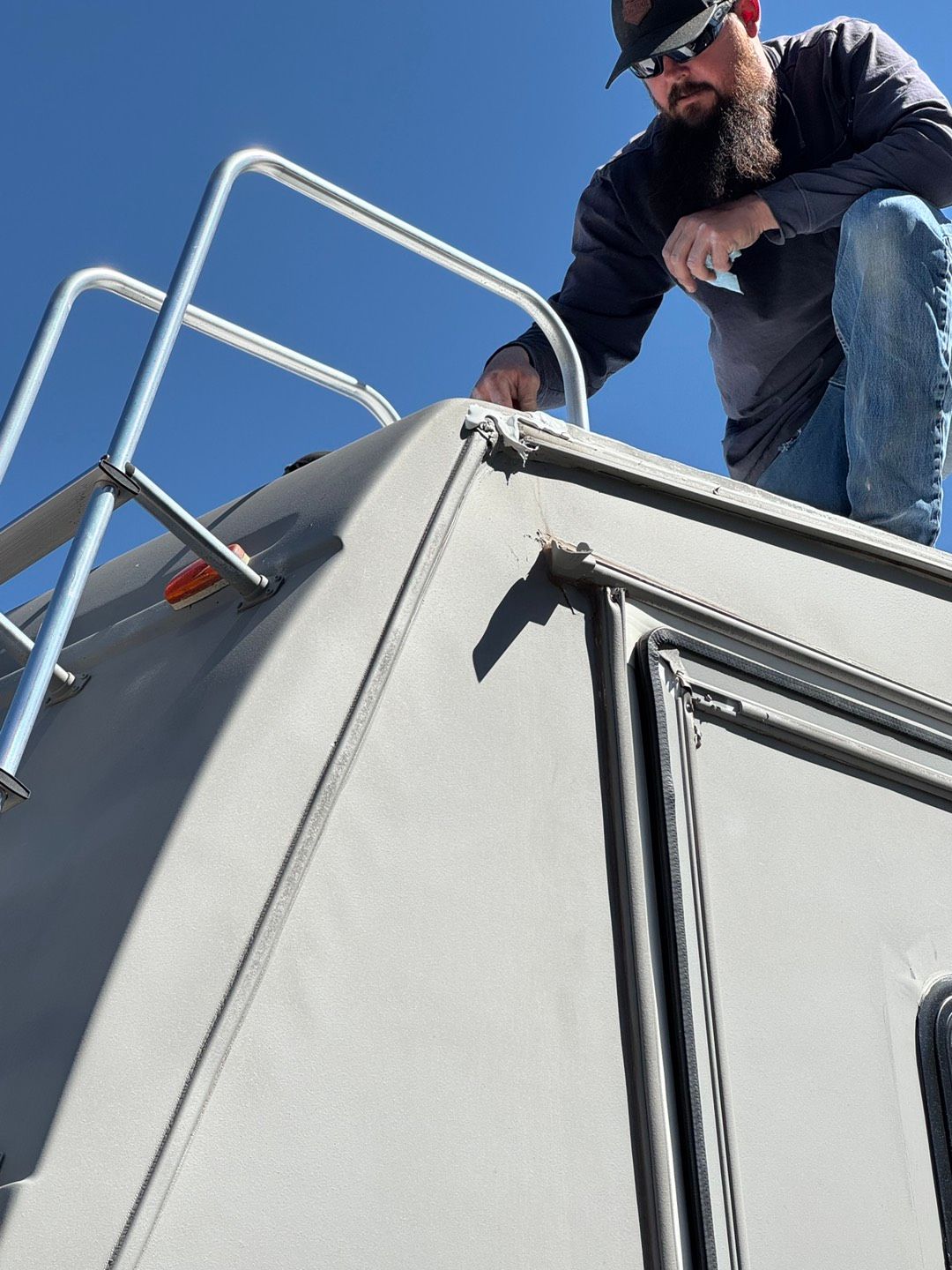 Row of white RVs parked outside.